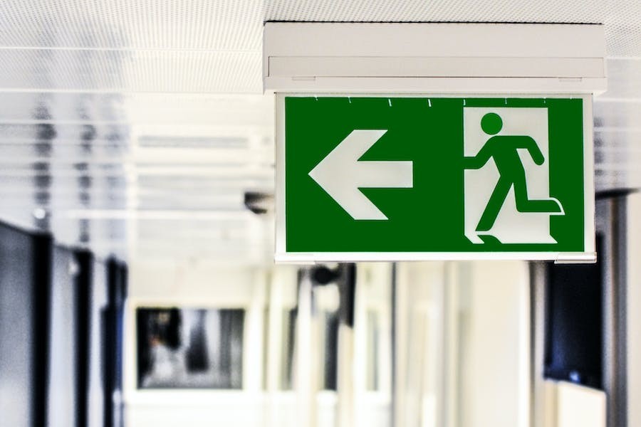 An exit signal indicating where to evacuate in an emergency.